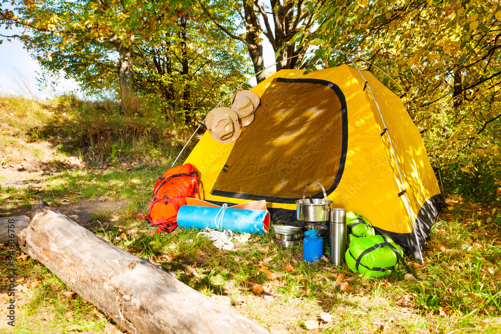 Beautiful campsite with tent, backpacks, day time