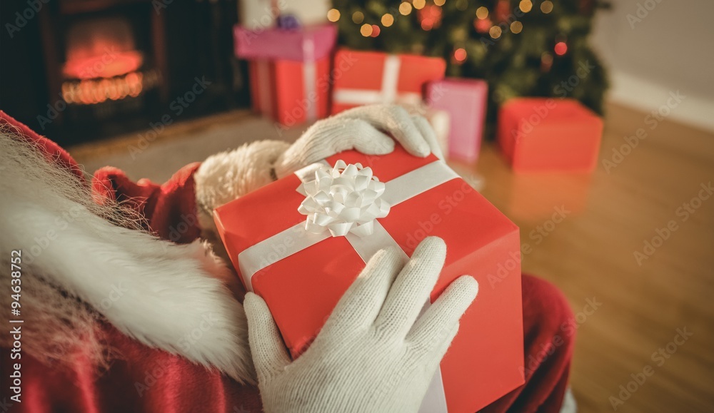 Santa claus holding a red gift