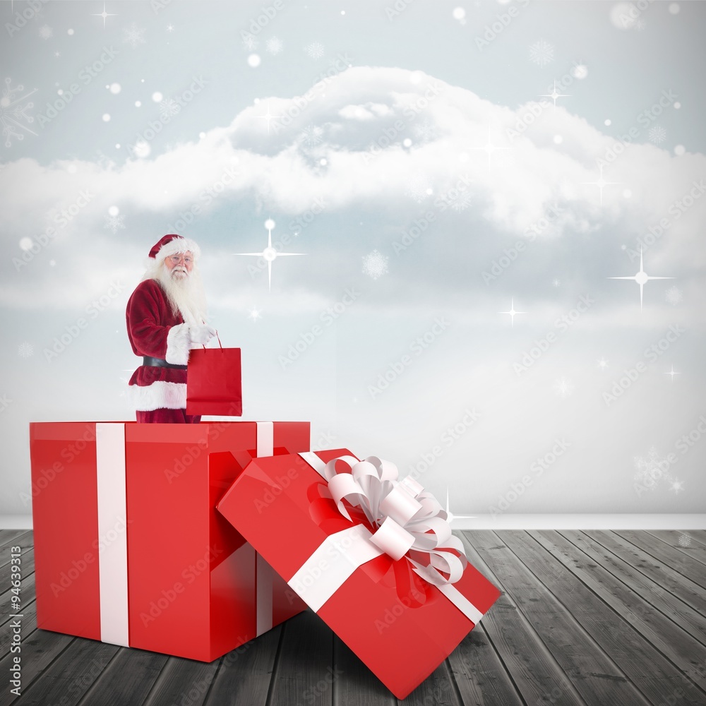 Composite image of santa standing in large gift