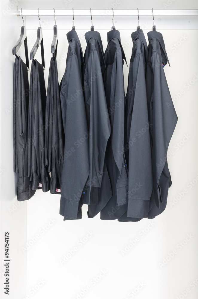 black clothes hanging on rail