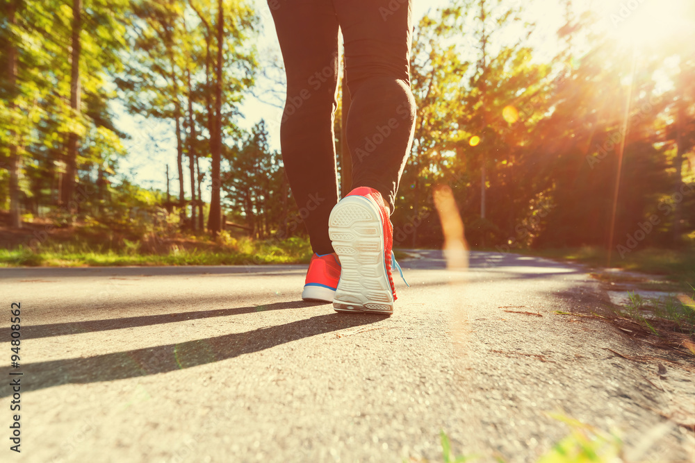 Woman jogging down an outdoor path