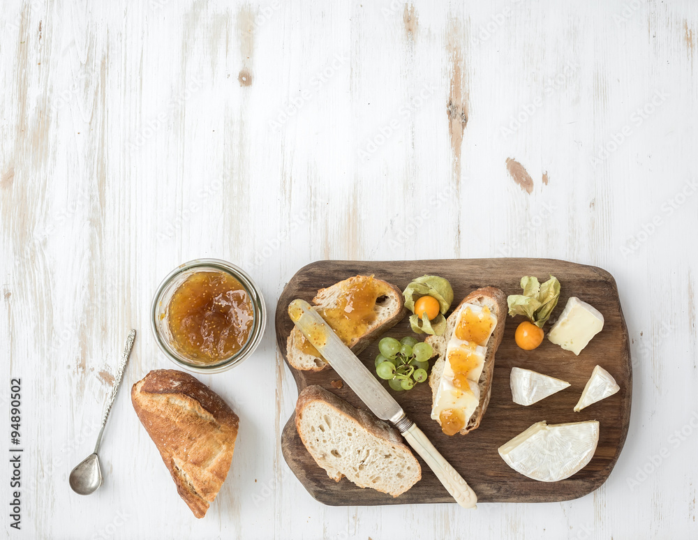 Breakfast set. Brie cheese and fig jam sandwiches with fresh grapes, ground cherries. Top view