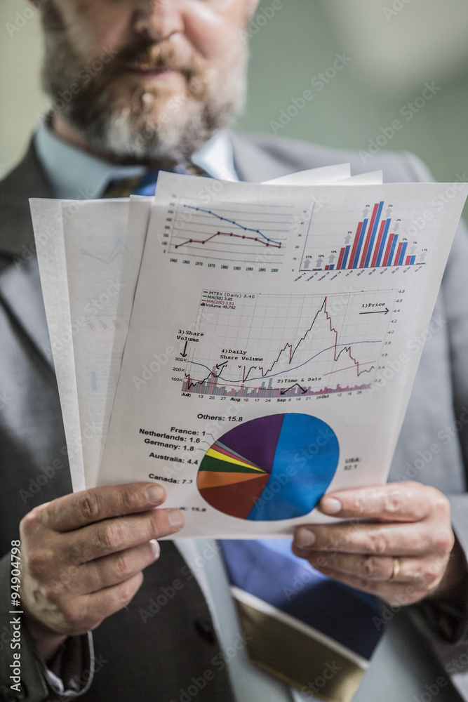 closeup businessman holding documents with business Analytics