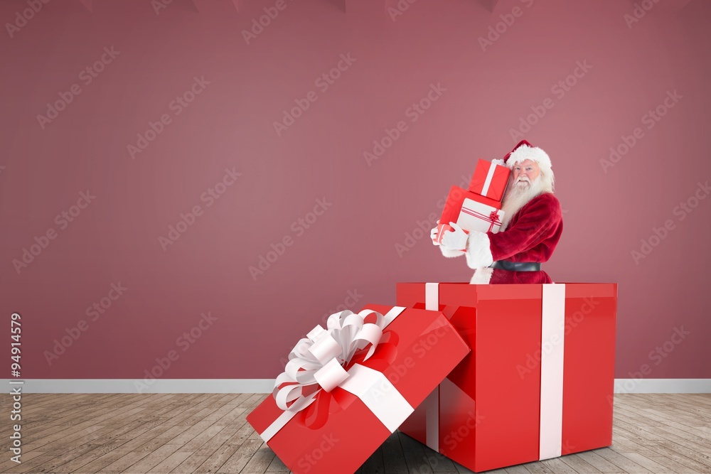 Composite image of santa standing in large gift