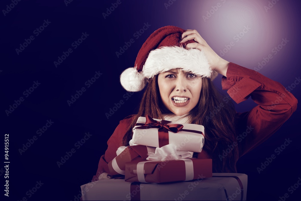 Festive stressed redhead holding gifts