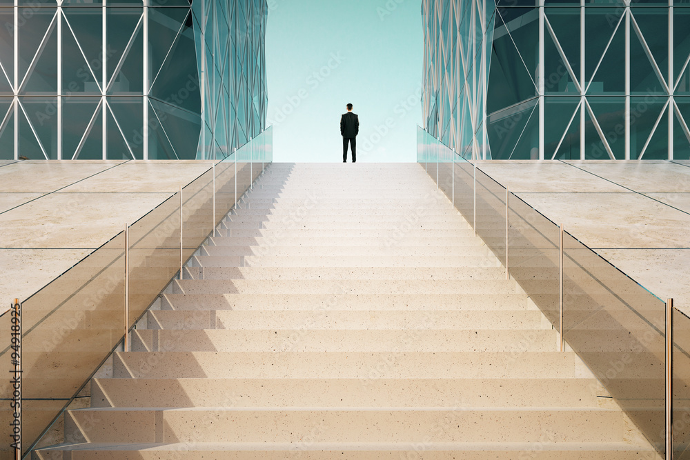 Businessman on the top of stairway between business centers outd