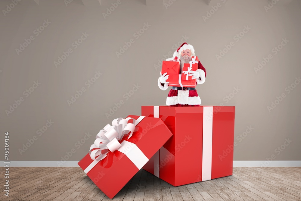 Composite image of santa standing in large gift