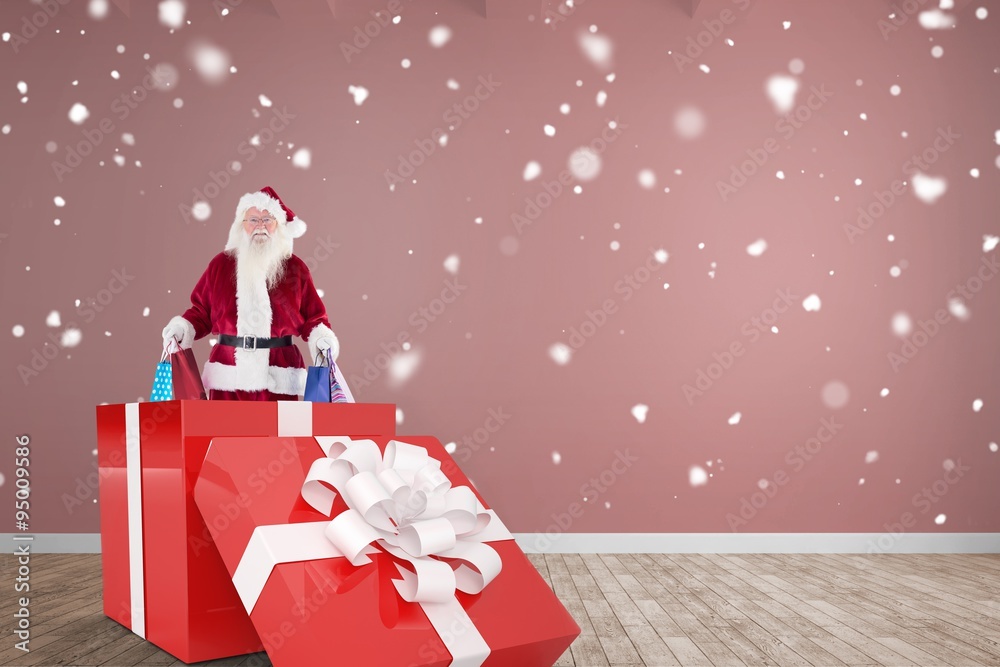 Composite image of santa standing in large gift