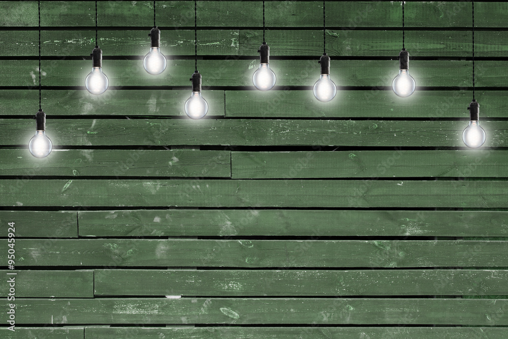 Idea concept - Vintage incandescent bulbs on wooden wall