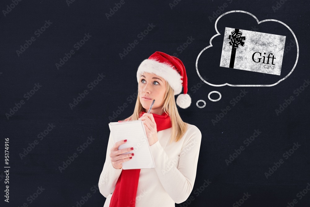 Composite image of festive blonde writing her christmas list