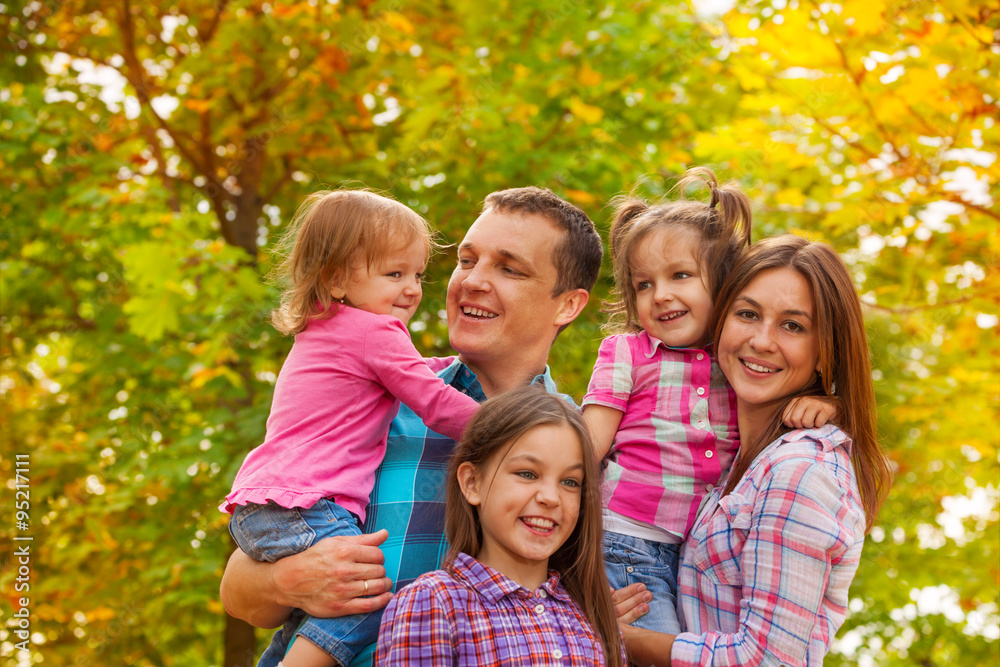 Happy family portrait with little girls outside