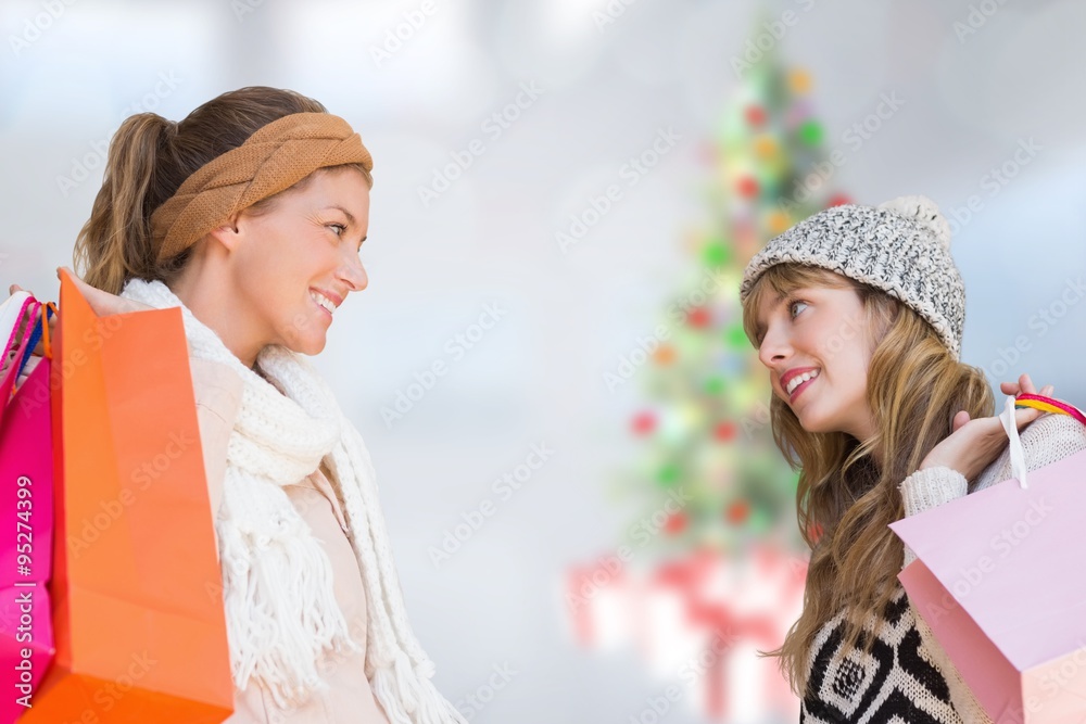 Composite image of smiling women with shopping bags