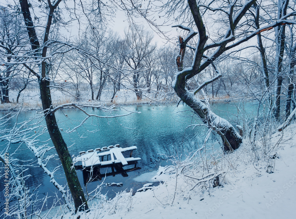 Winter landscape with river in forest