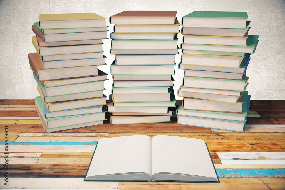 Three piles of books and blank diary in the middle on wooden tab