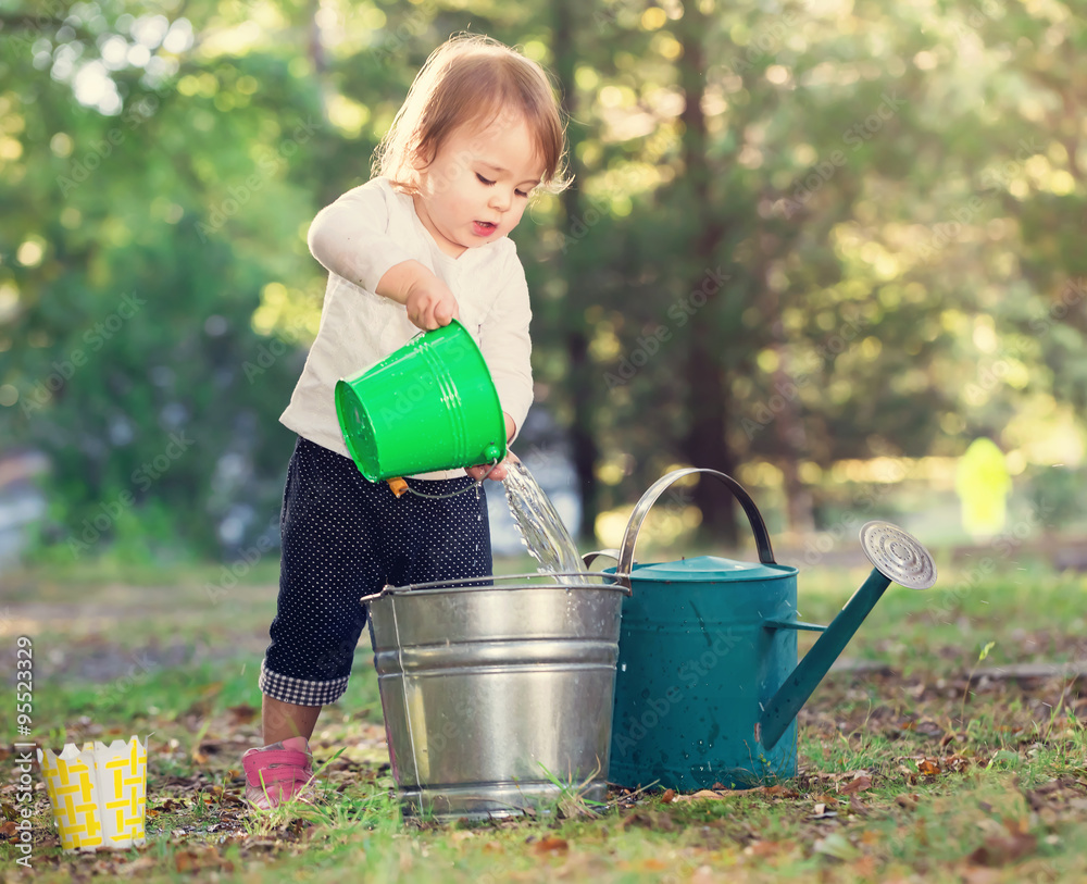 Happy toddler girl playing outside