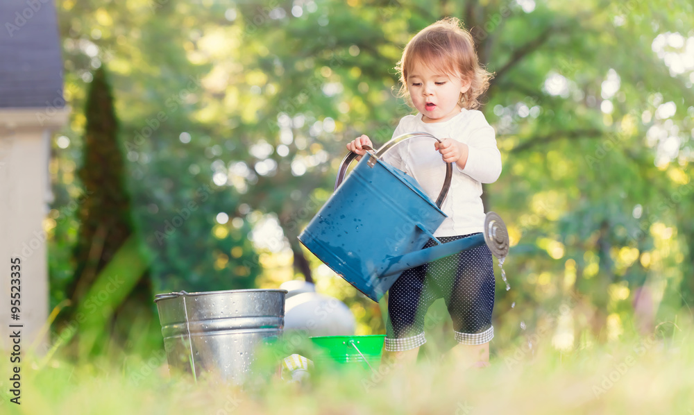 Happy toddler girl playing outside