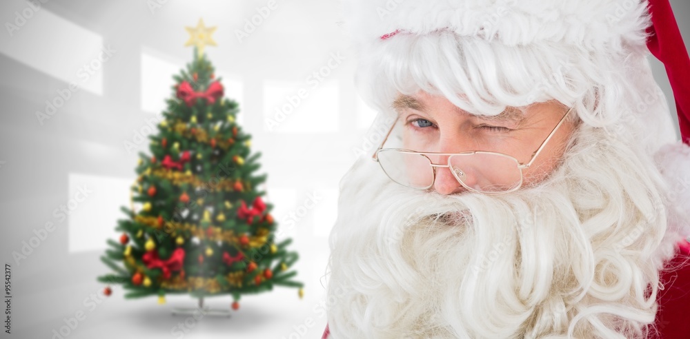 Composite image of portrait of santa claus winking