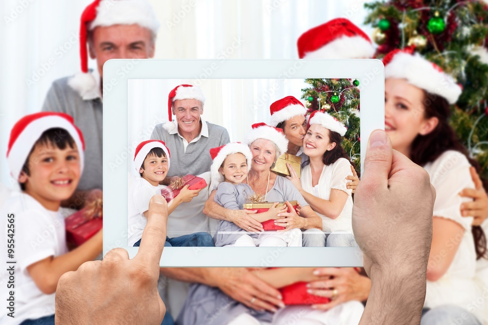 Composite image of hand holding tablet pc