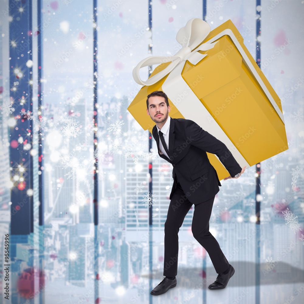 Composite image of stylish man with giant gift