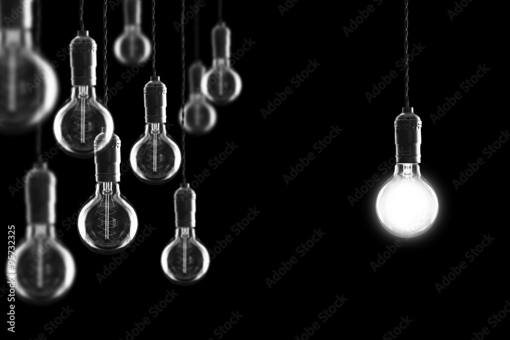 Idea and leadership concept Vintage incandescent Edison bulbs on