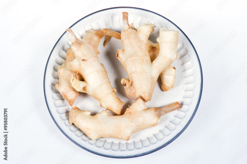 fresh ginger in white plate on  white background