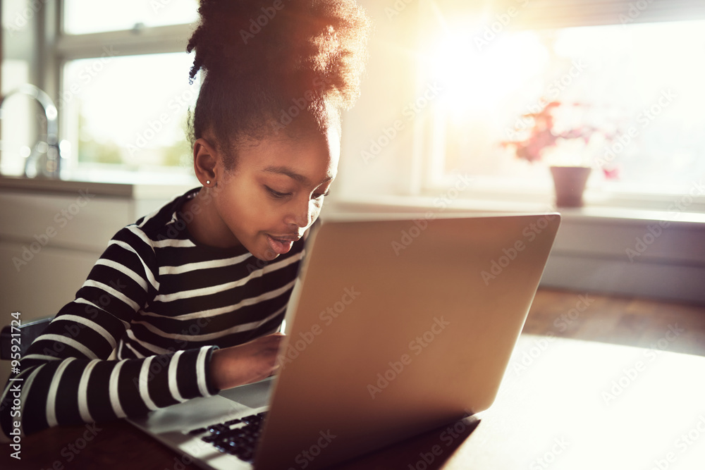 Young African girl amusing herself at home