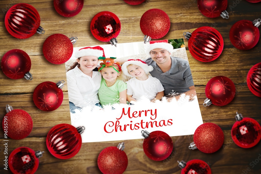 Composite image of christmas baubles on table