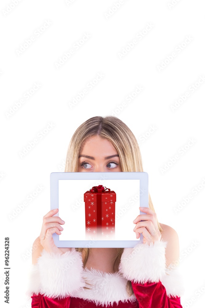 Composite image of pretty santa girl holding tablet