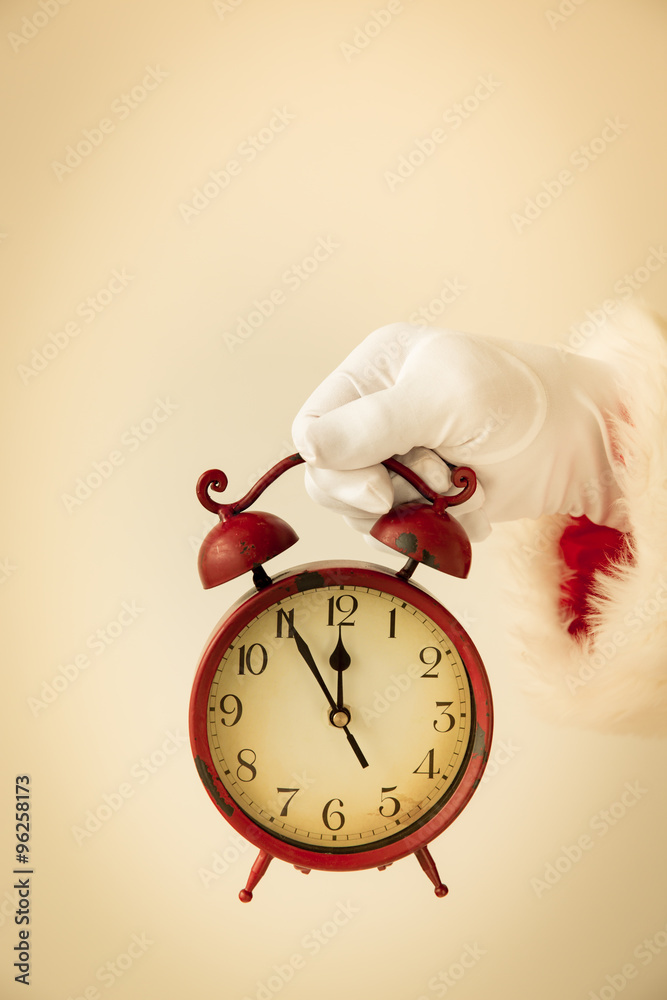 Santa Claus holding vintage alarm clock