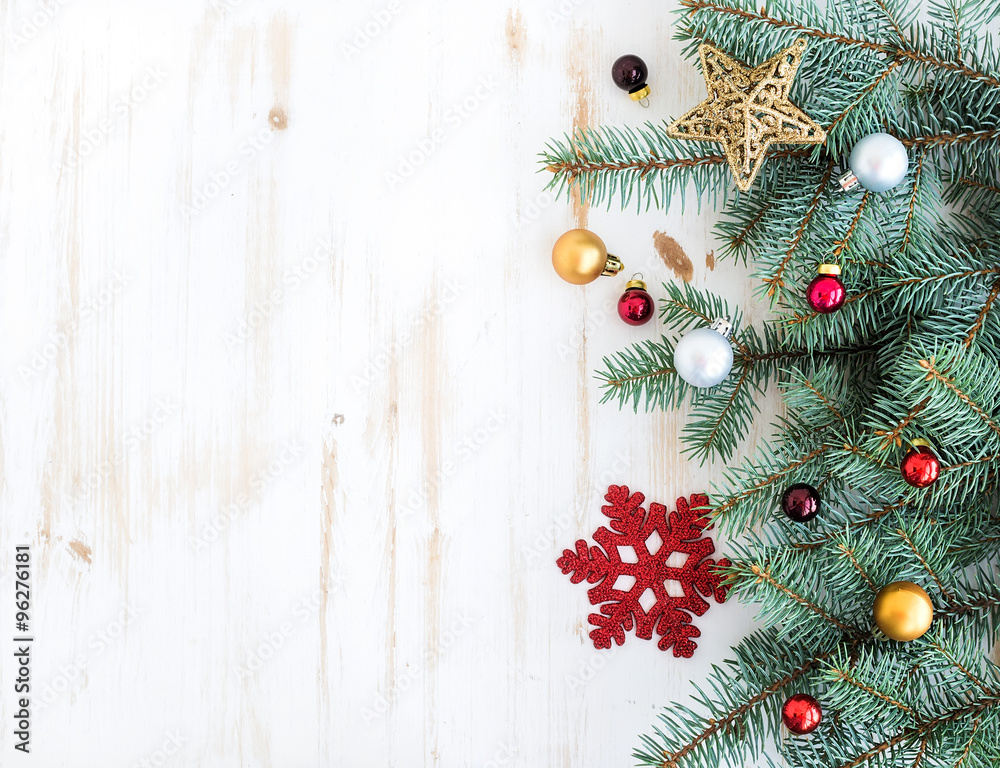 Christmas or New Year decoration background: fur-tree branches, colorful glass balls and glittering 