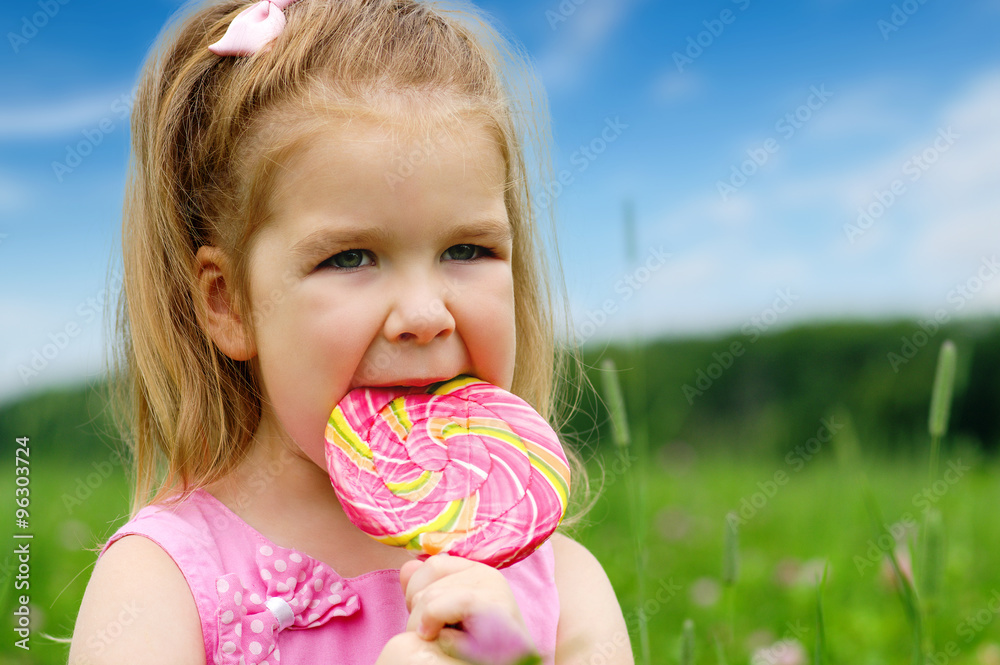  little girl eating a lollipop