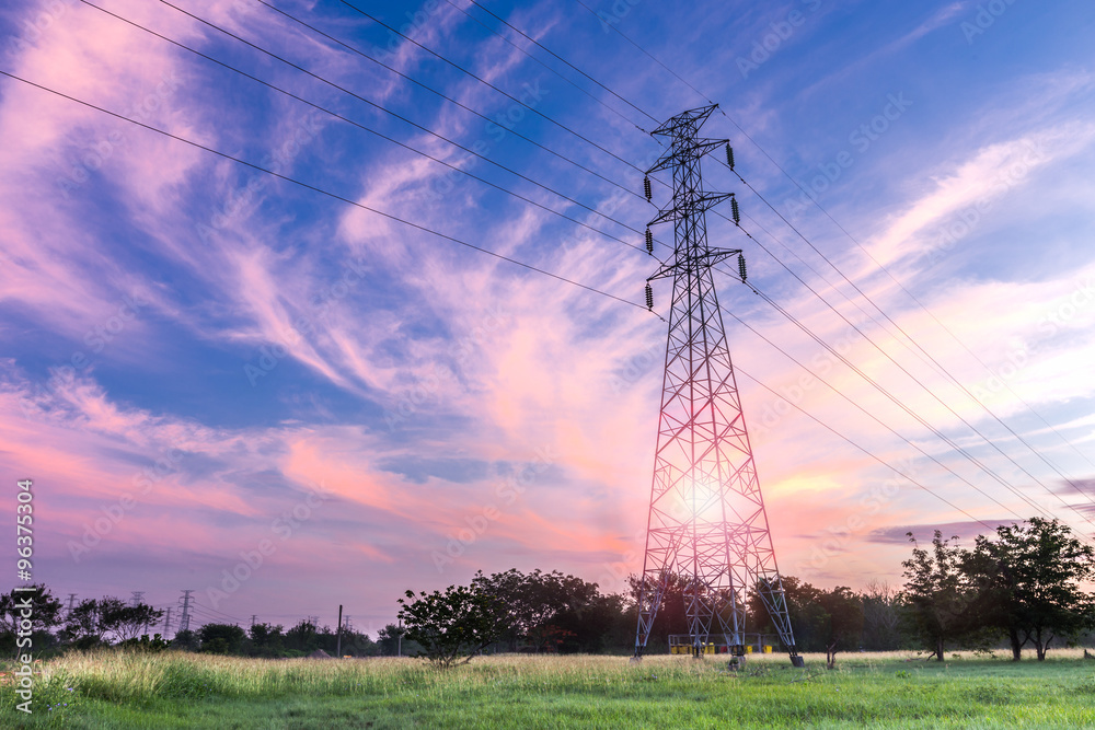 High voltage electricity pylon on sunrise background