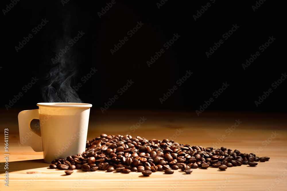 Paper cup of coffee with smoke and coffee beans on wooden table