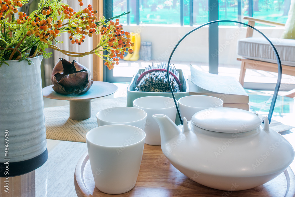 teapot, cup and vase on table in living room