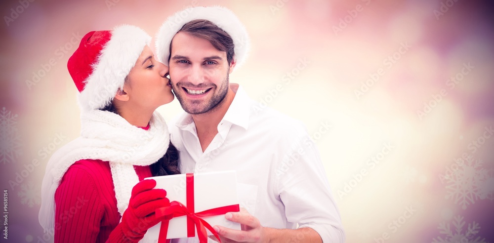 Composite image of festive young couple holding gift