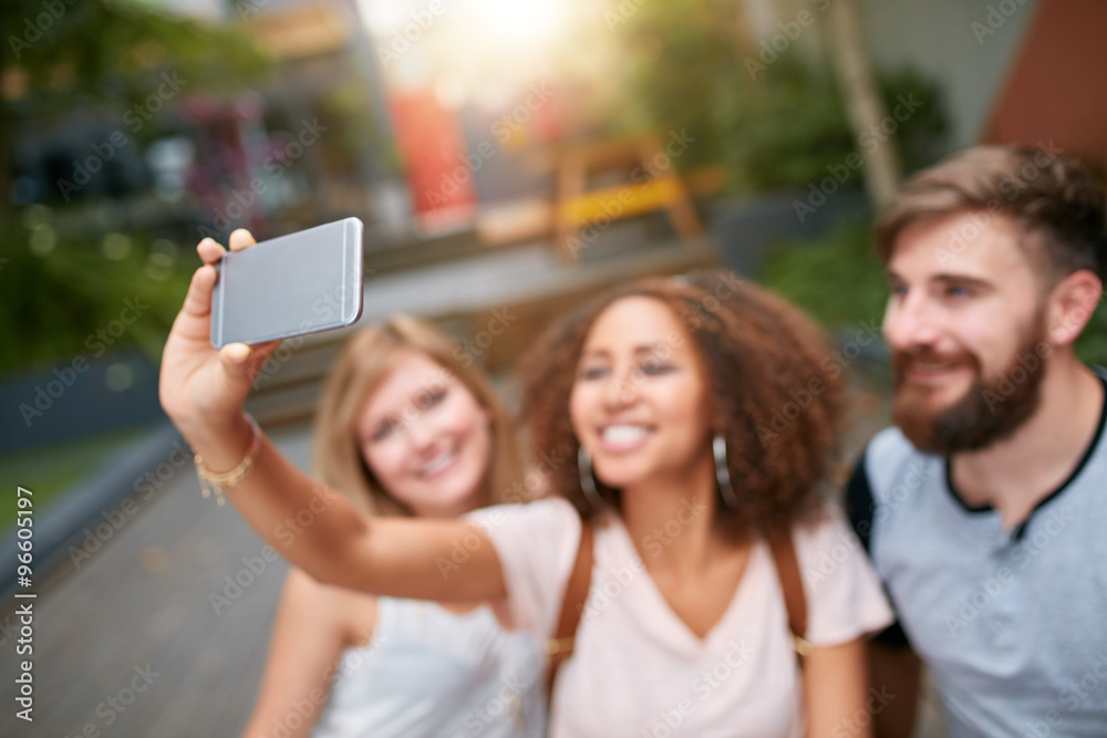 Young woman taking selfie with friend