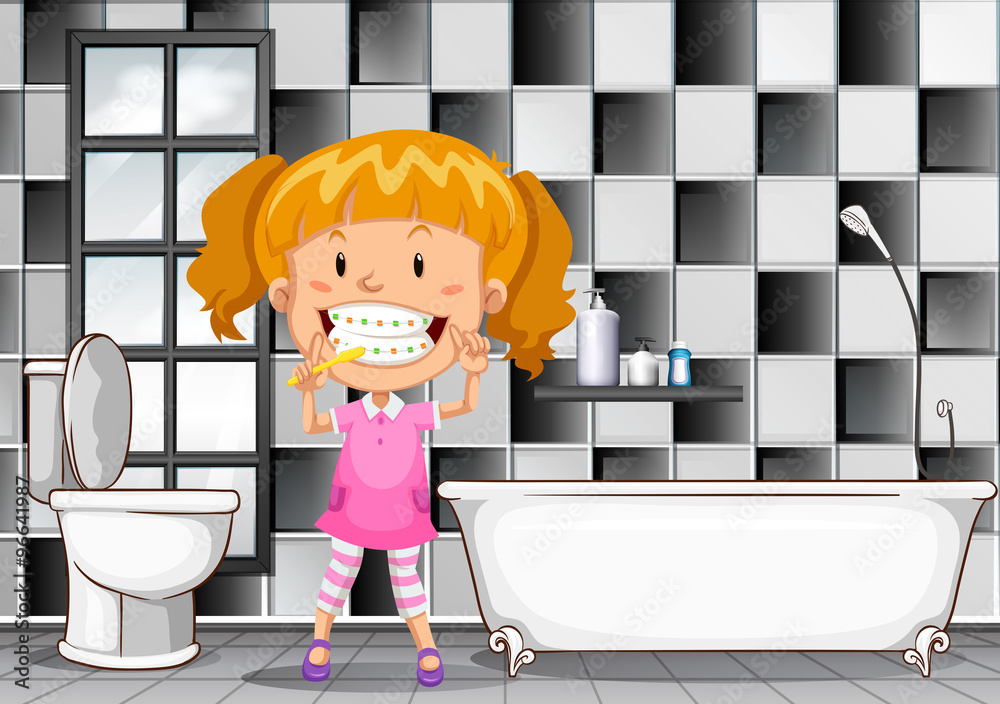 Little girl brushing teeth in bathroom