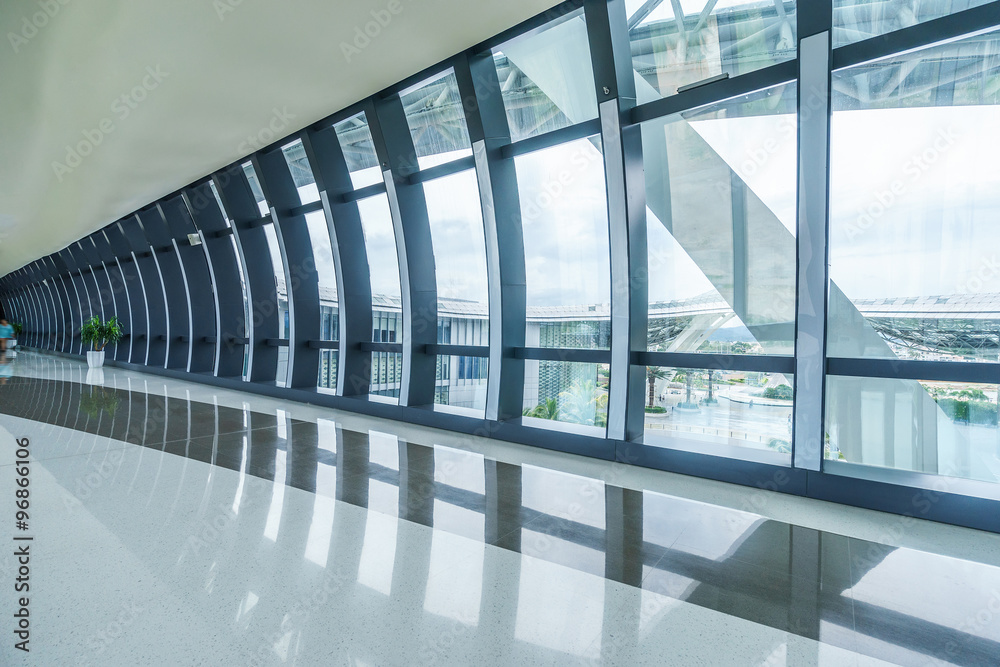 corridor with many glass windows in modern shopping mall