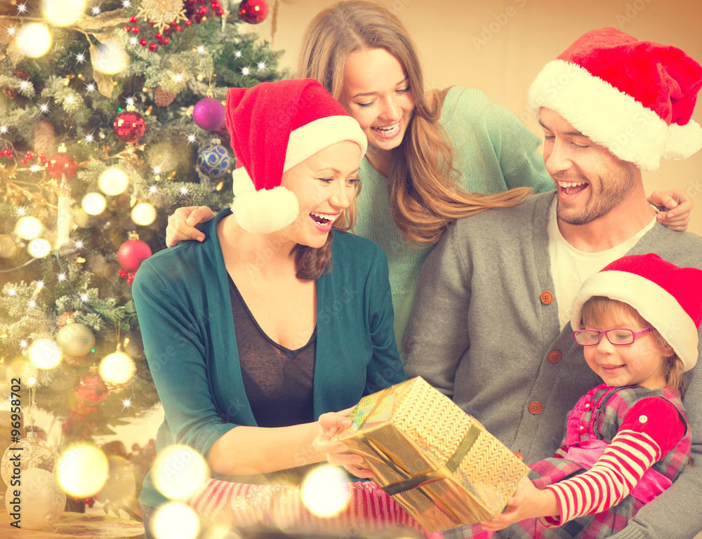 Happy smiling family at home celebrating Christmas