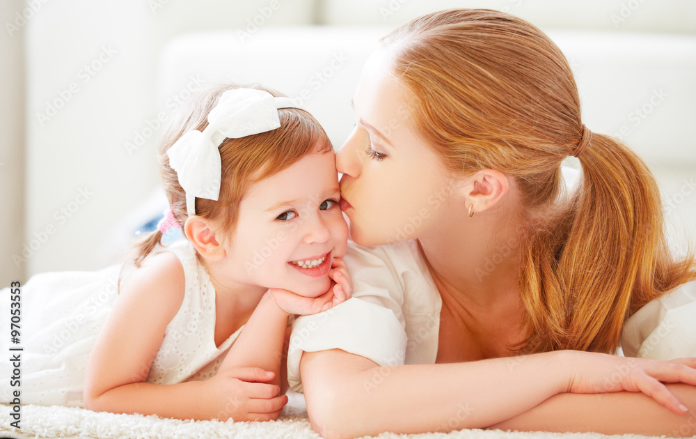 happy family. Mom kisses her little child