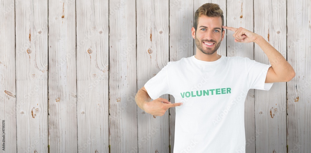 Composite image of a happy male volunteer pointing