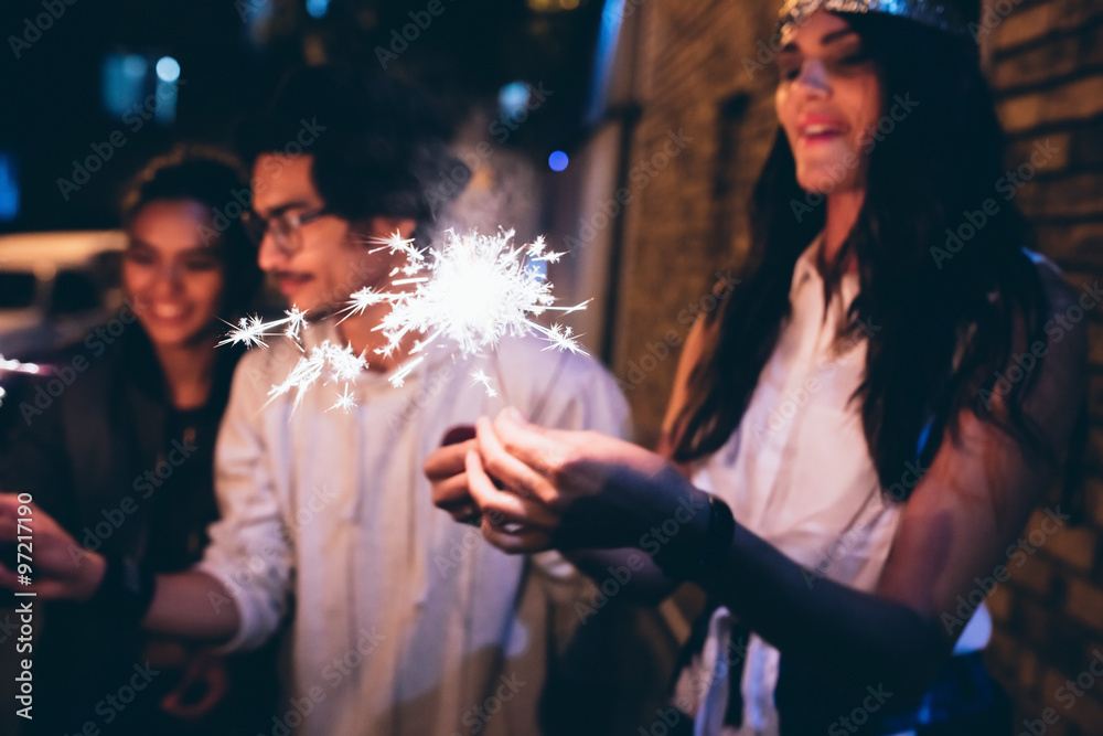 Young friends celebrating with sparklers