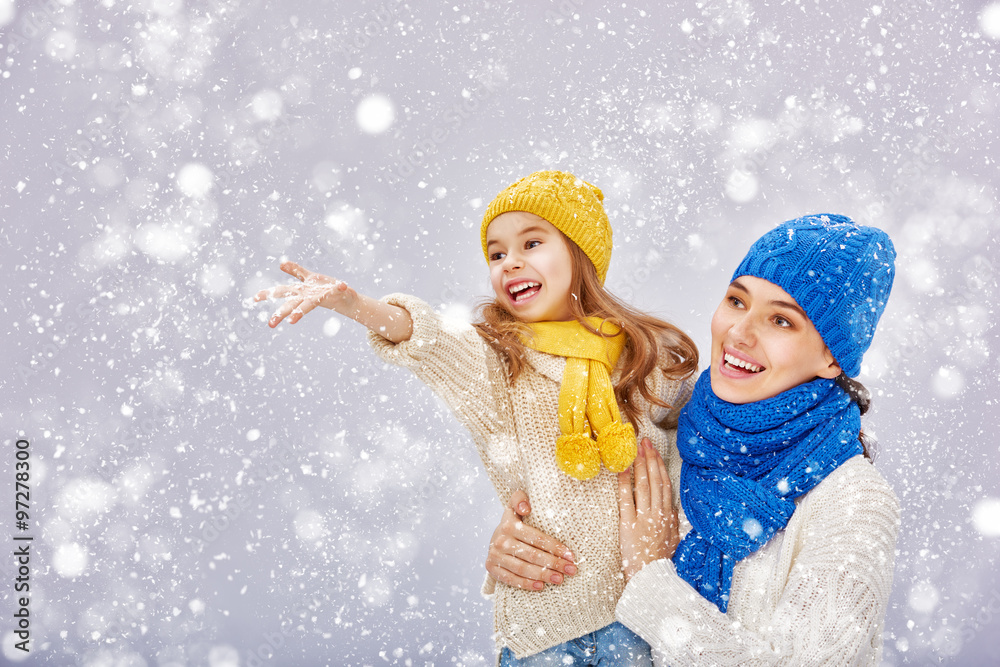 Mother and child girl on a winter walk