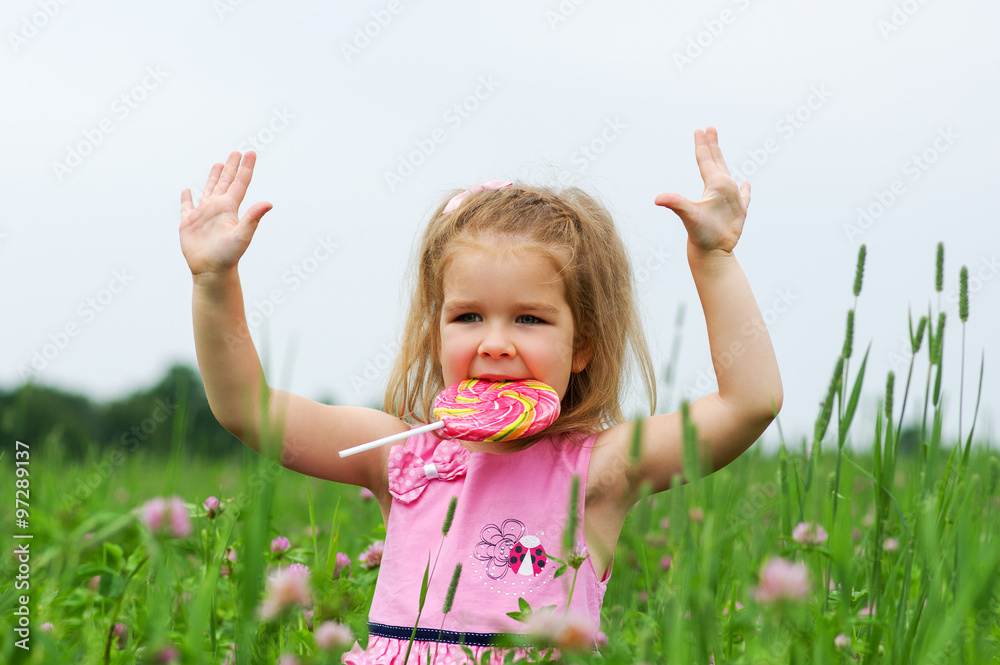  little girl eating a lollipop