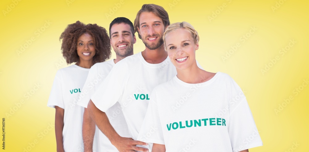 Composite image of smiling volunteer group