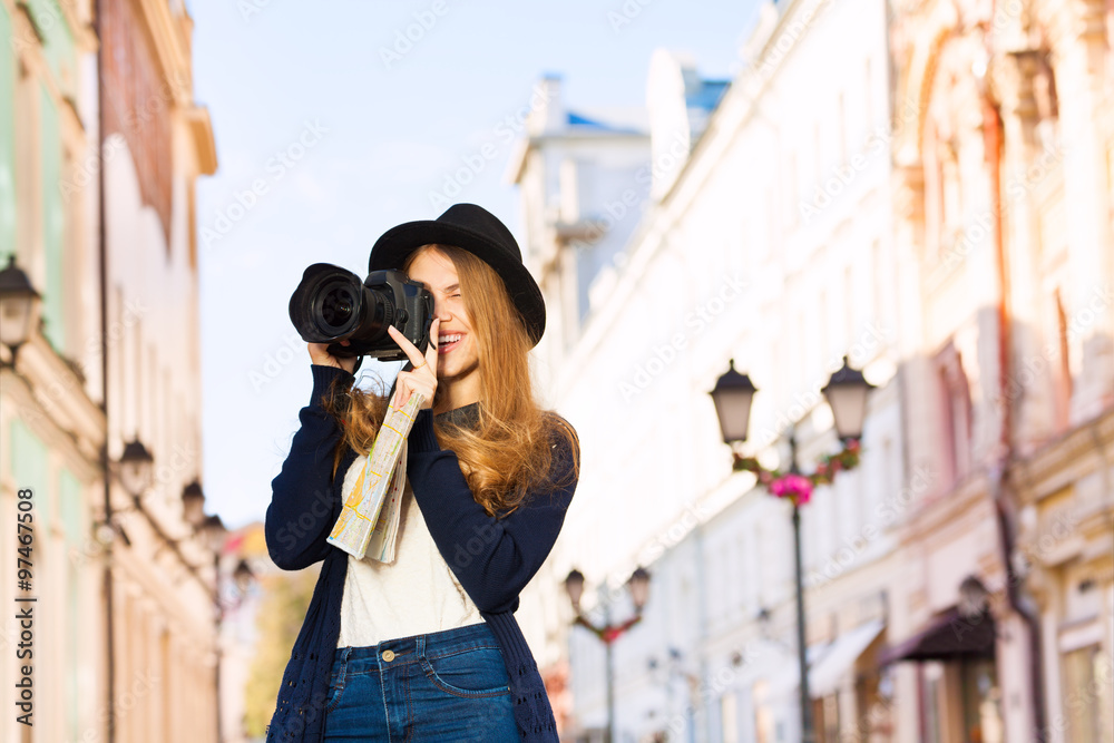 Beautiful young woman shooting with camera