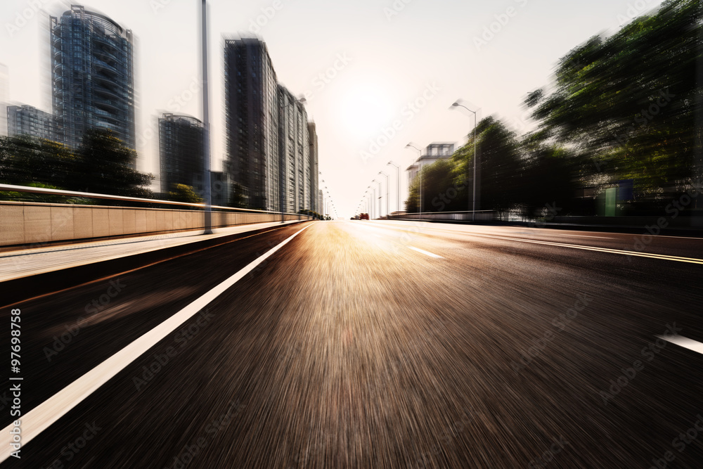 sunlight skyline and road by modern buildings