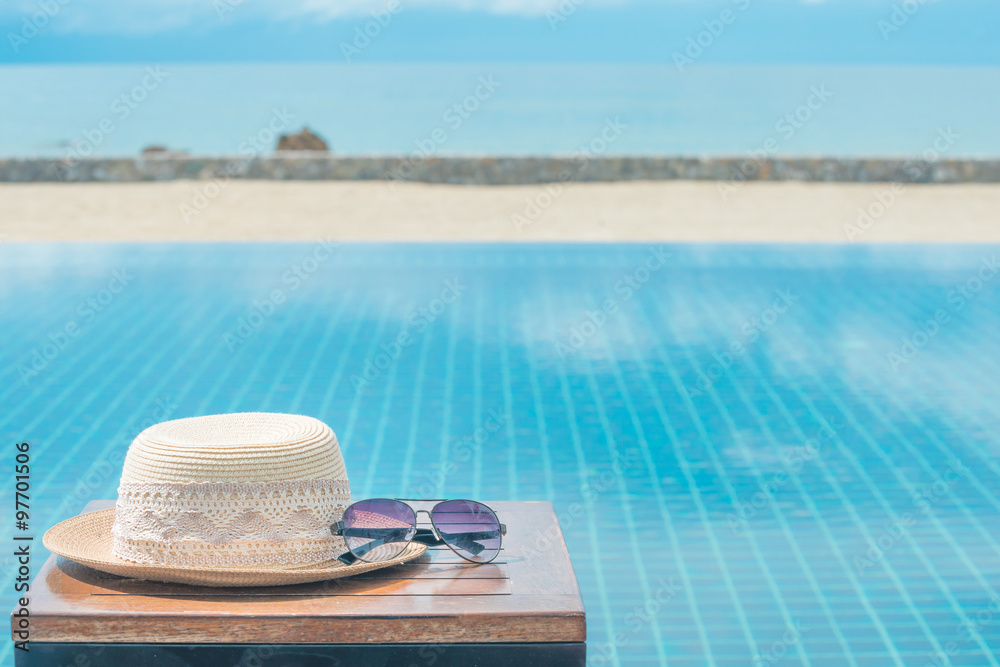 Hat and sunglasses at the sea background