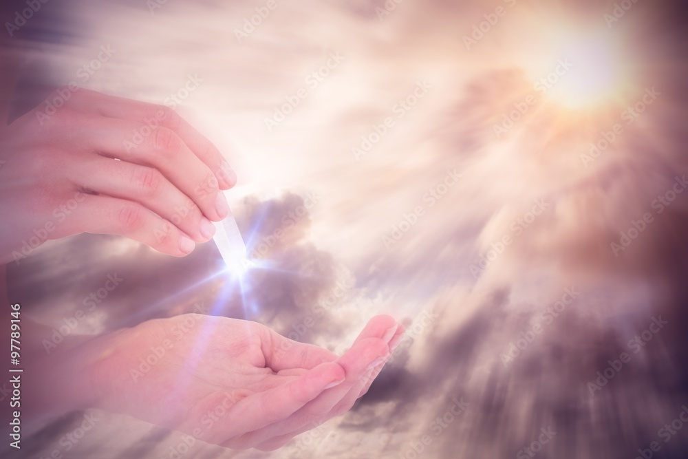 Composite image of woman holding precious gem