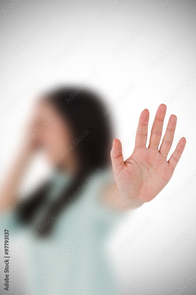 Composite image of irritated woman showing her hand